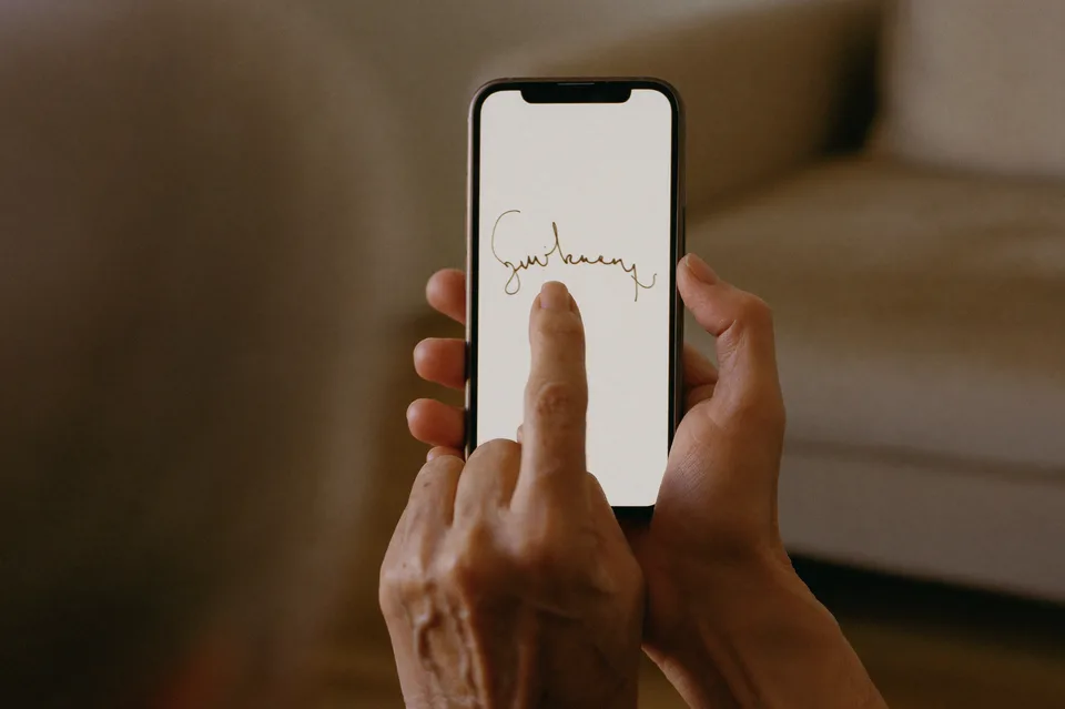 Klient unterschreibt mit dem Finger auf einem Smartphone